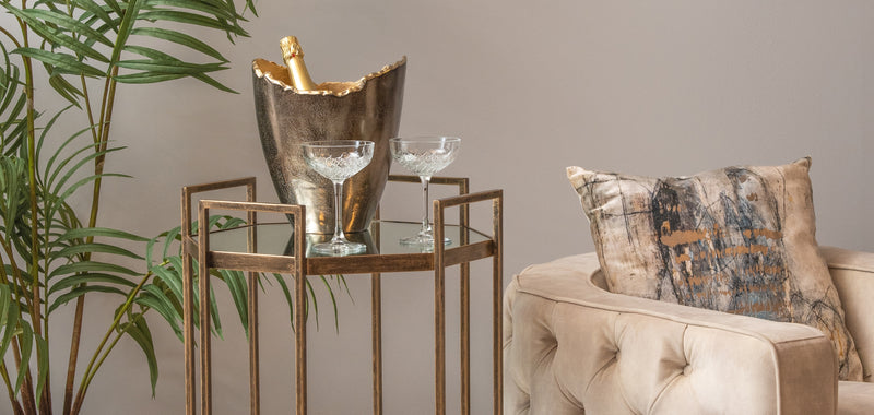 drinks trolley with an bucket and cocktail glasses on.
