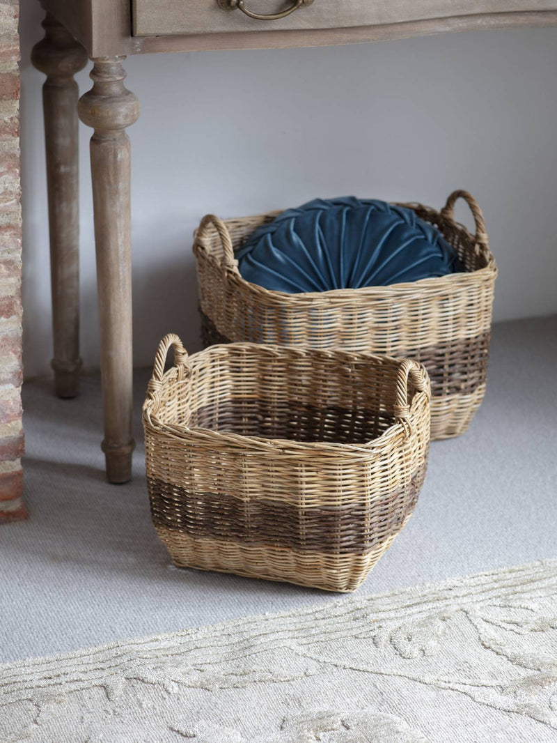 two rectangle woven storage baskets underneath a console table
