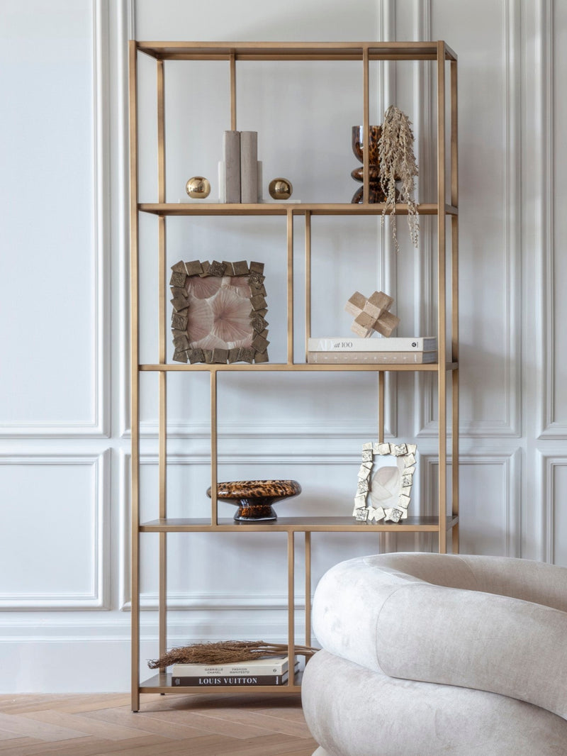 A tall shelf unit featuring quirky and unique home ornaments.