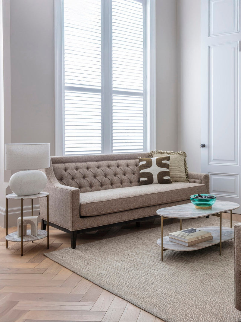 a neutral living room sofa with two sofa cushions on
