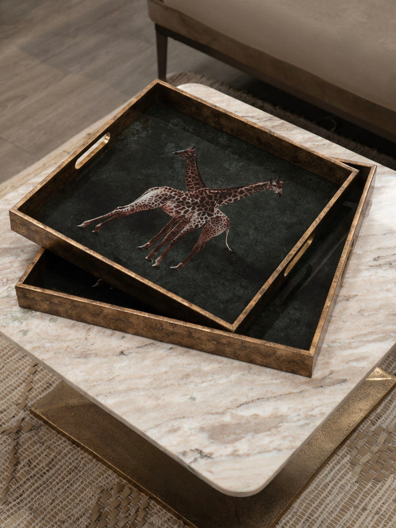 Two square decorative trays, stacked on top of one another, with a picture of two giraffes