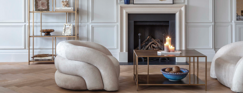 A living room with two armchairs, a coffee table with candles, all part of our bestsellers collection