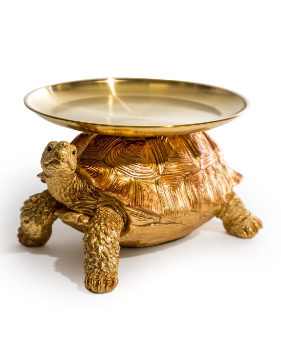 A decorative gold and bronze tortoise with a gold tray on its back.