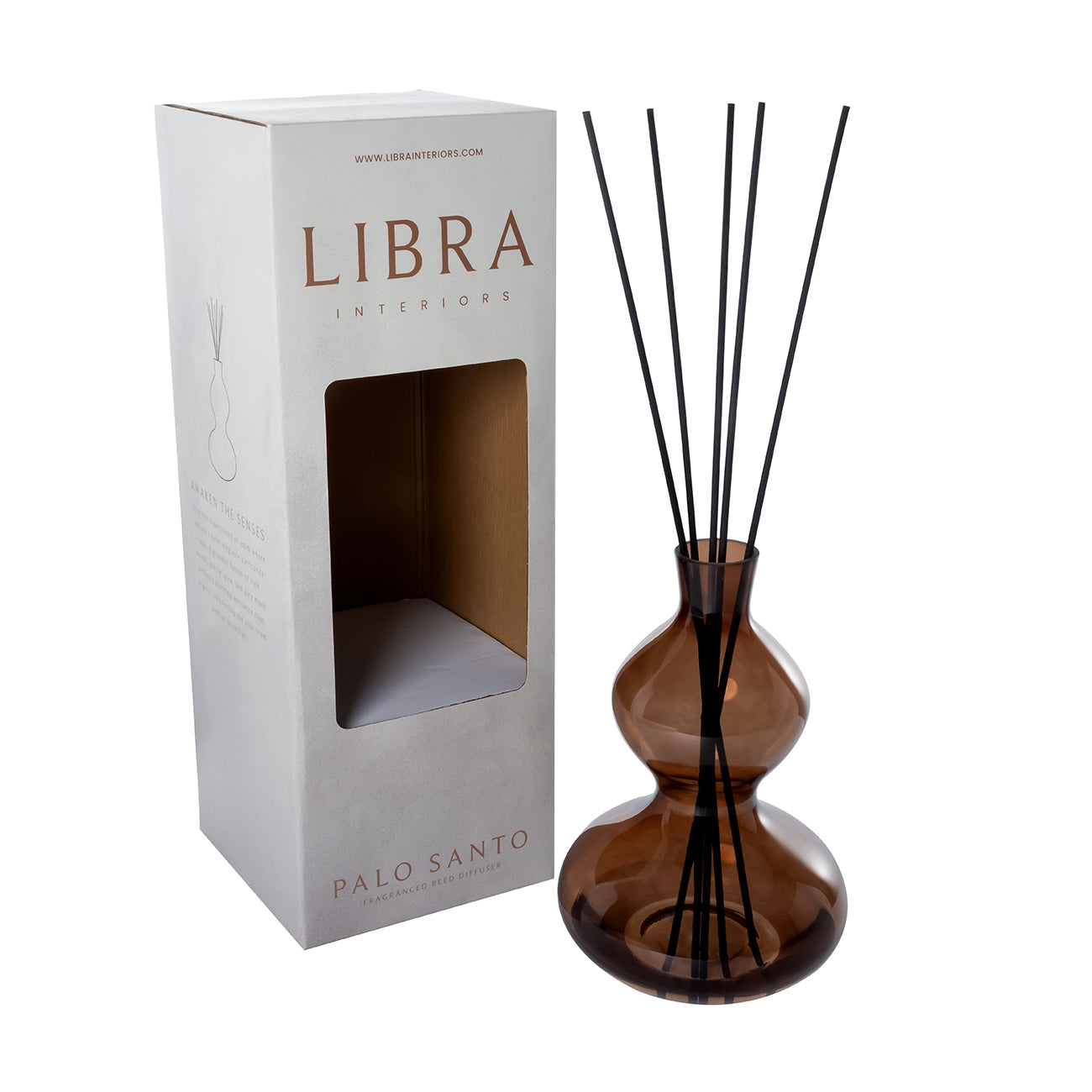 Brown diffuser bottle with black sticks and Libra Interiors packaging on a white background
