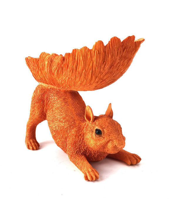 Orange squirrel figurine with a bowl in its tail