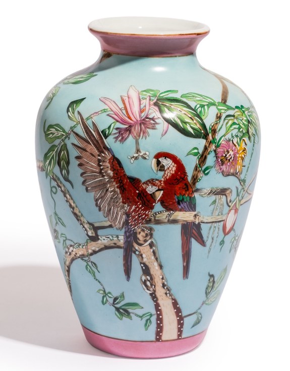 Decorative vase with parrot and floral design on a light blue background