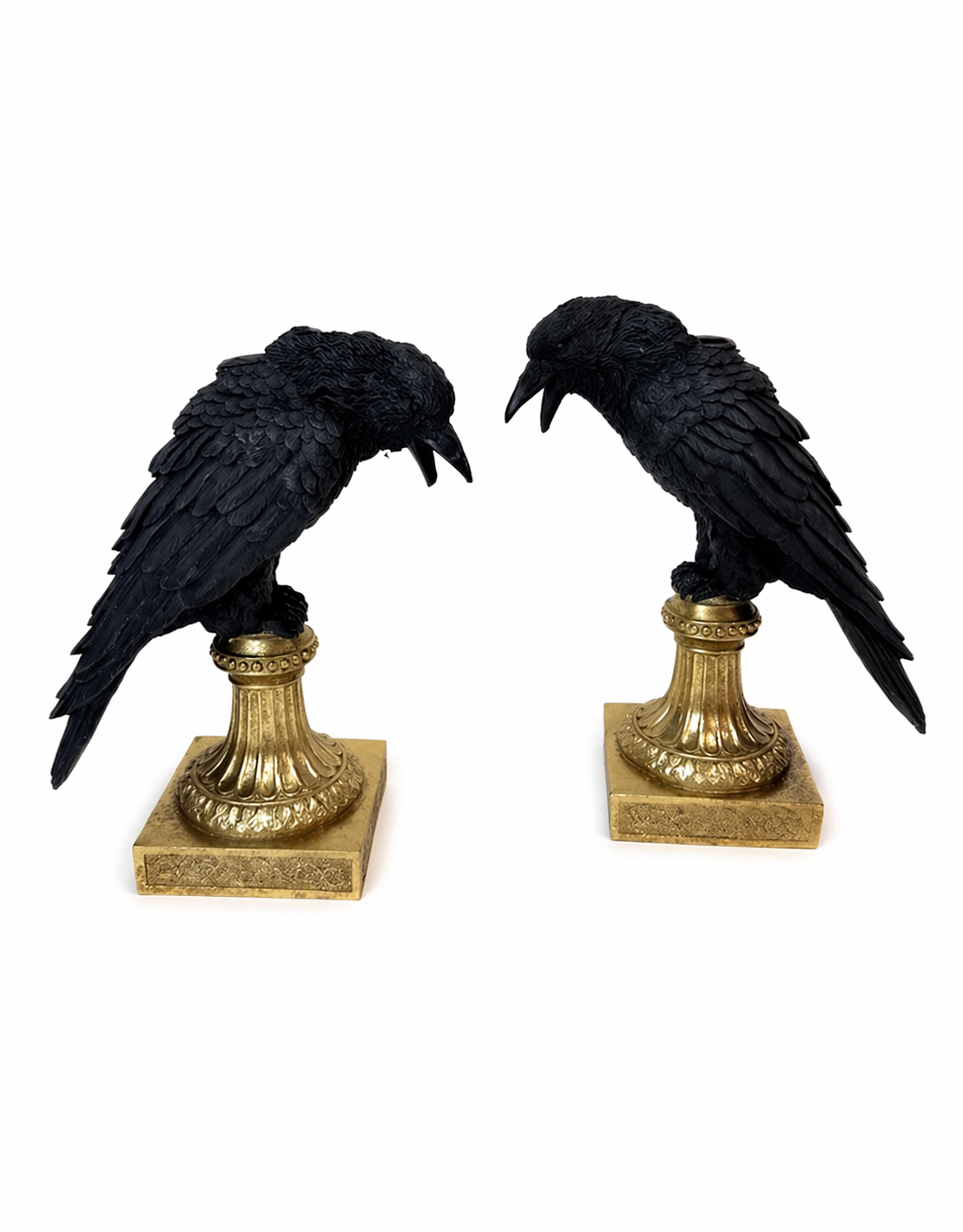 Two black raven statue candle holders on gold pedestals 