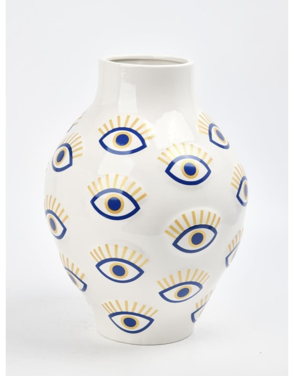 White vase with blue and yellow eye pattern