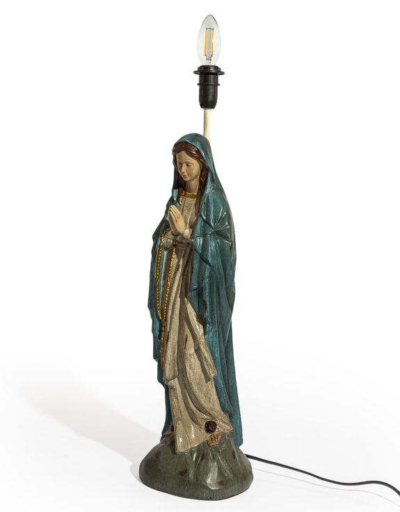 A religious table lamp featuring a painted statue of the Virgin Mary with a teal cloak and beige gown.