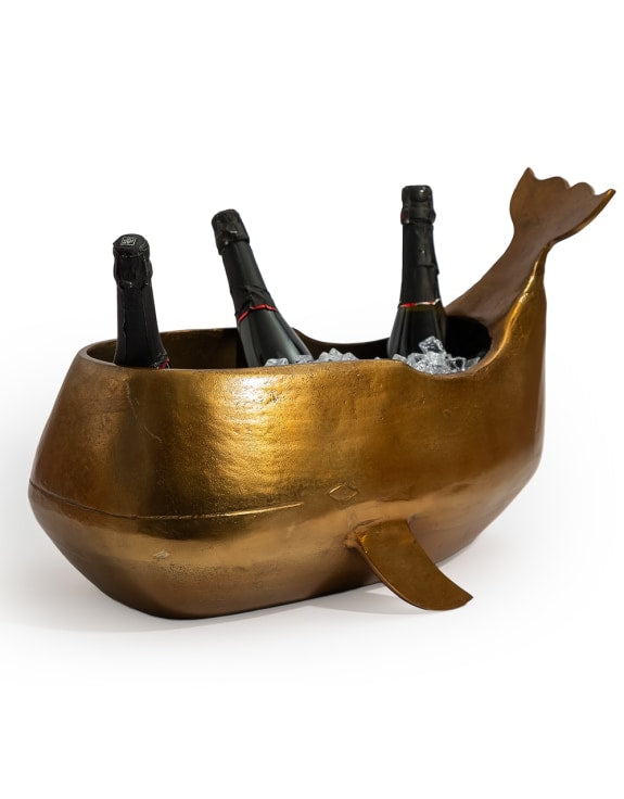 A whale-shaped metallic ice bucket in a warm gold/bronze finish.