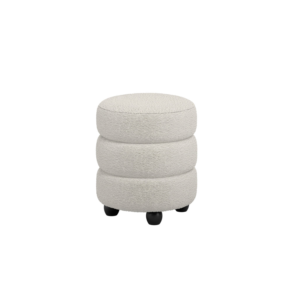 Round upholstered ivory boucle footstool with stacked design and black wooden feet.