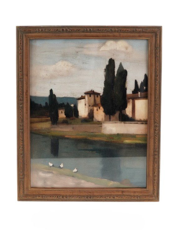 Framed painting of a landscape with a building and trees by a lake.