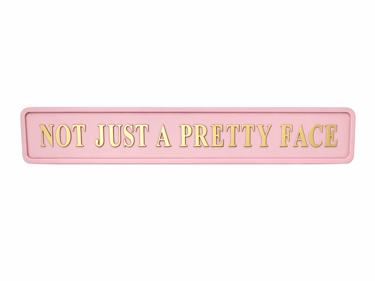 Pink sign with gold text 'NOT JUST A PRETTY FACE' 