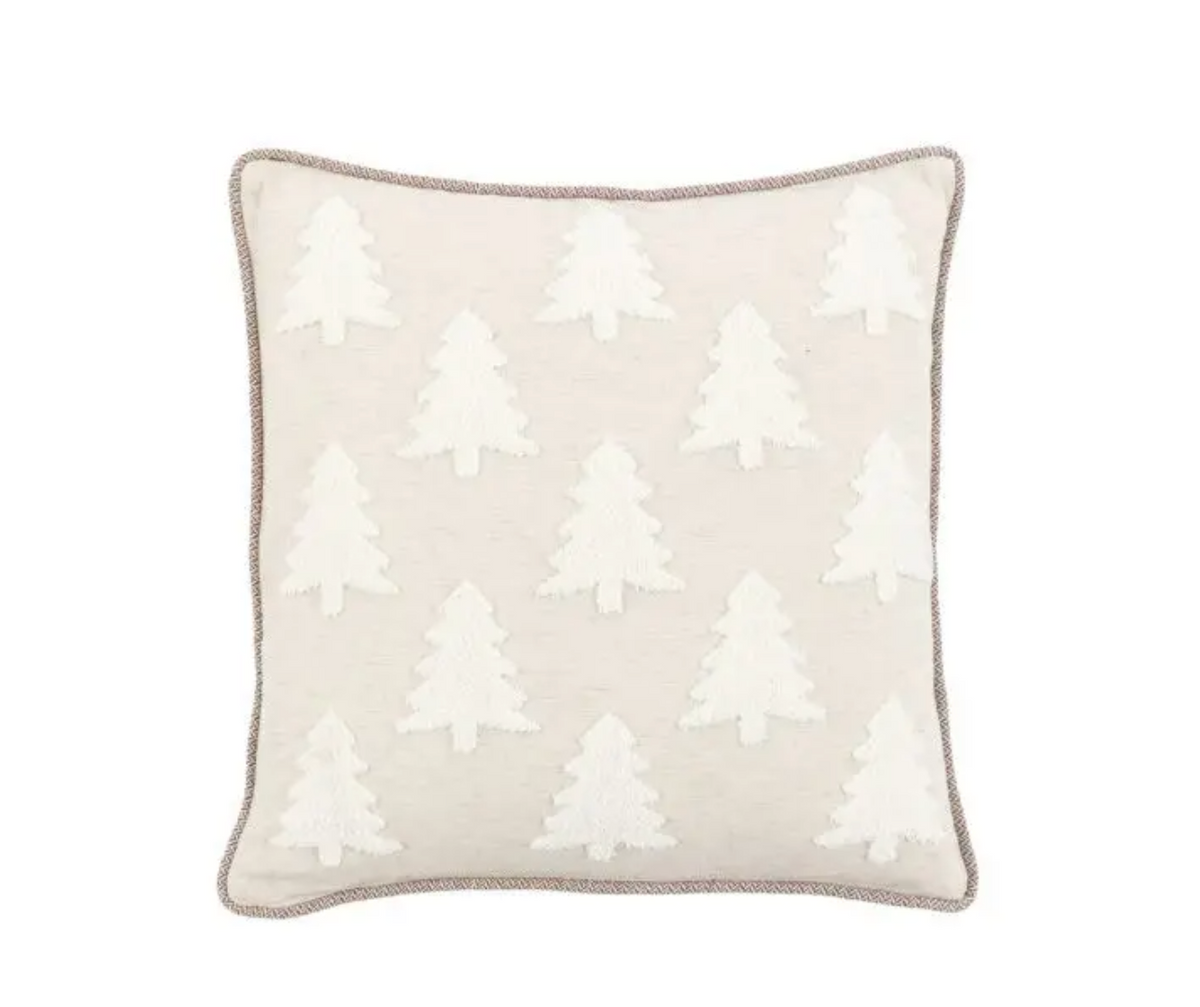 A square throw pillow in a light beige linen fabric featuring a repeating white embroidered pine tree pattern, finished with a contrasting taupe-gray piped edge.