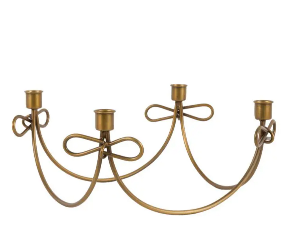 Antique gold candle holder made from metal with gold detailing. 