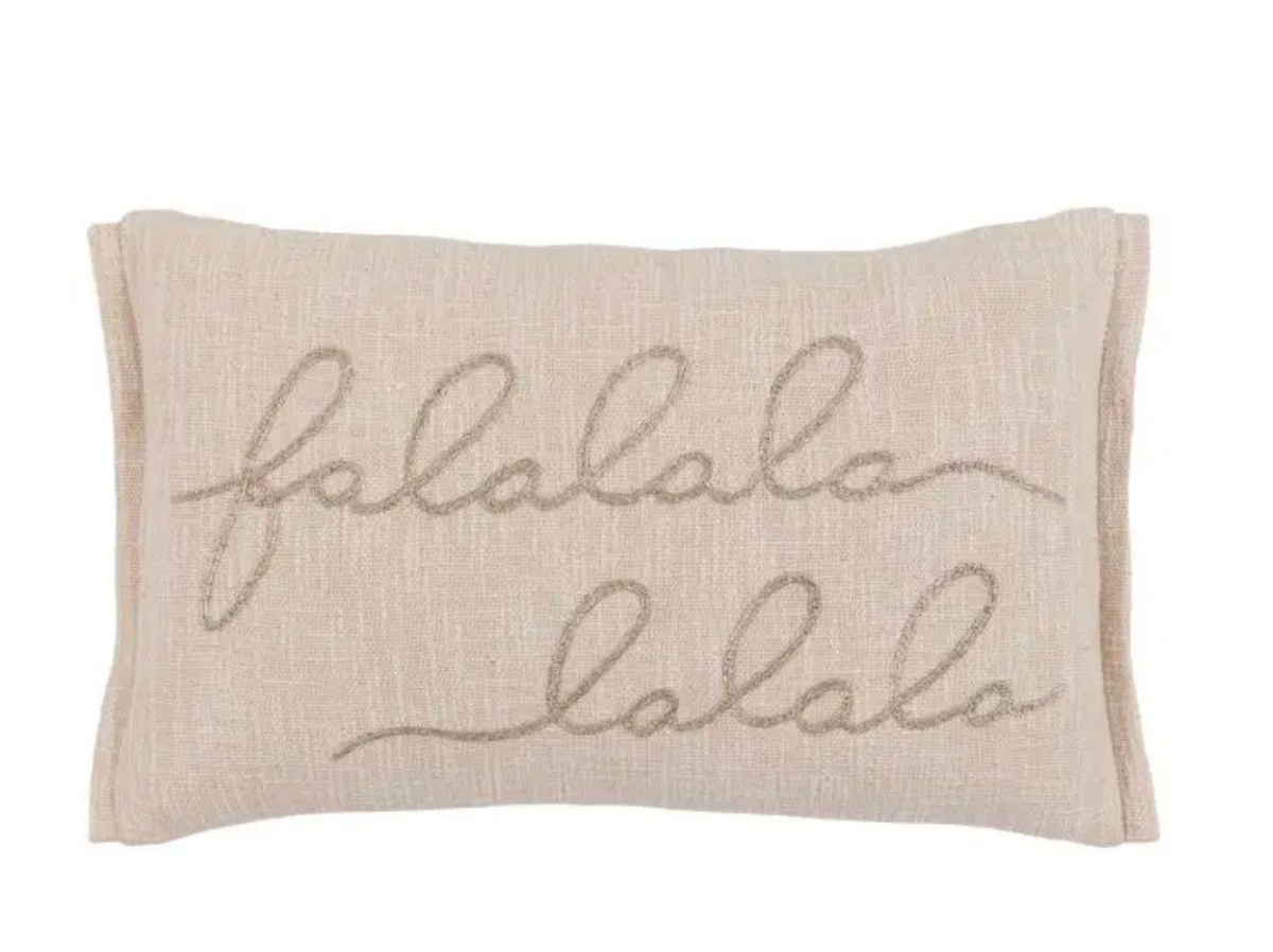 A rectangular beige linen lumbar pillow featuring the word 'lalala' embroidered in a cream cursive script.