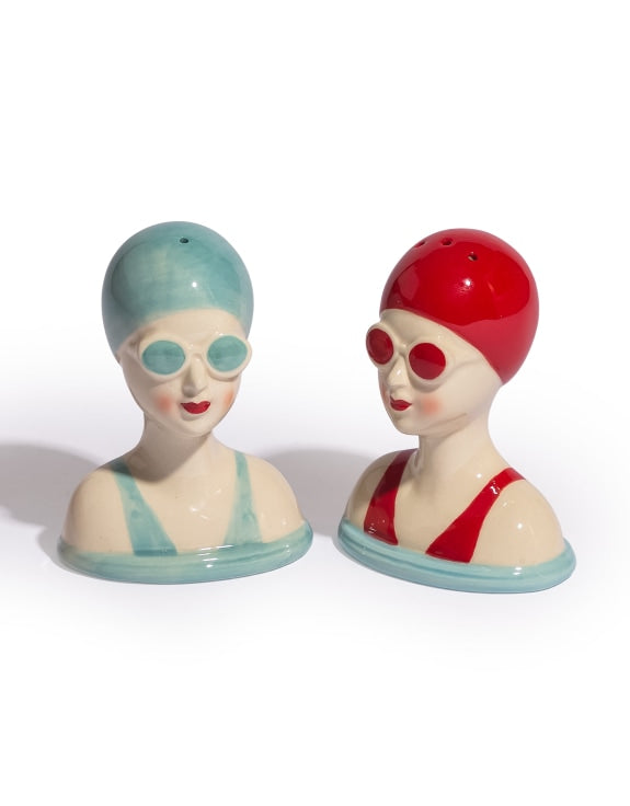 Two Salt and papper shakers in the shape of women in swimsuits and hats 