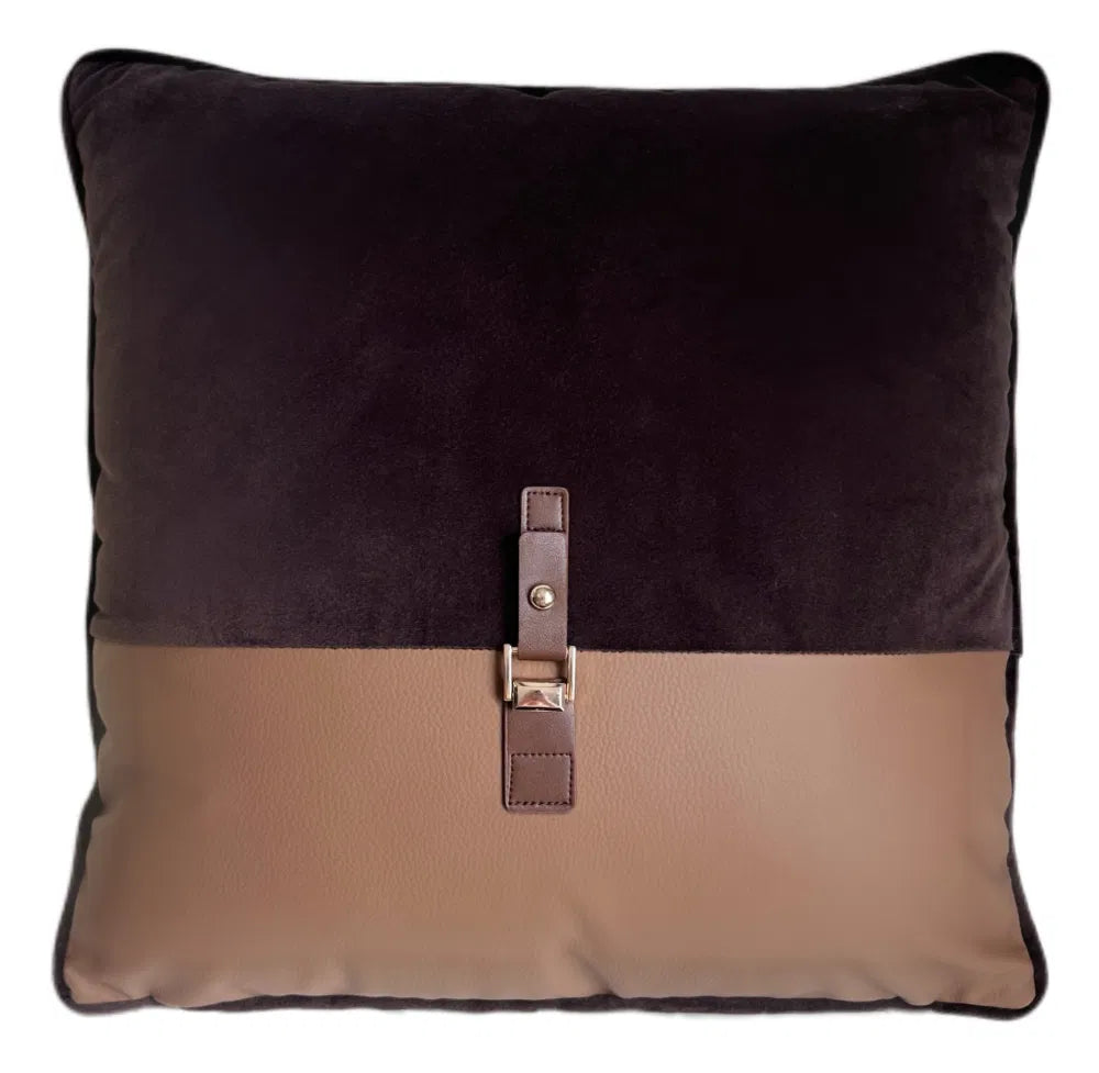 Two-toned brown and beige cushion with a leather strap and buckle 